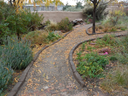 A winding gravel path with adobe edging